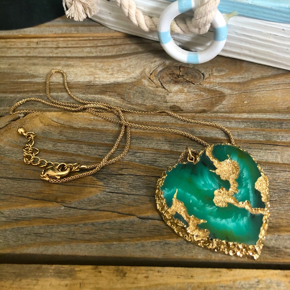 necklace with green stone pendant in heart shape